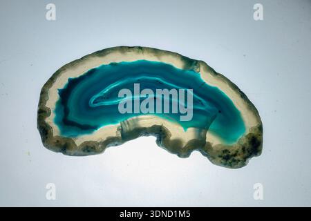 Close-up of a translucent blue agate slice on white background. Stock Photo