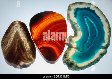 composition of three polished agate stones in blue, red, and brown tones. Stock Photo