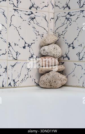 Raw exfoliating tools made from volcanic rock arranged in a quiet, clean bathroom space — ideal for sustainable lifestyle visuals. Stock Photo