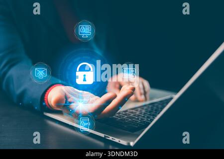 Hands holding glowing padlock hologram above laptop with email, mobile, card, desktop security icons, conveying concept cybersecurity, privacy, secure Stock Photo