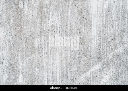 Textured concrete wall with streaks and abrasions. Rough gray concrete surface with subtle tonal variations, creating an impressive urban industrial b Stock Photo
