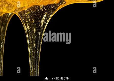 Flowing golden honey with air bubbles texture Stock Photo