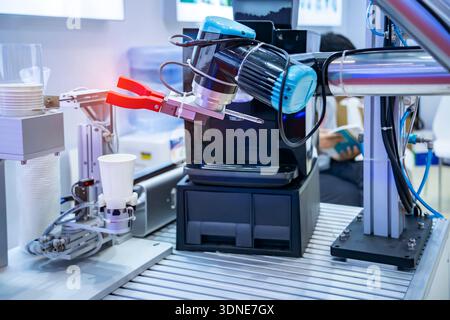automatic arm preparing coffee in coffee machine Stock Photo