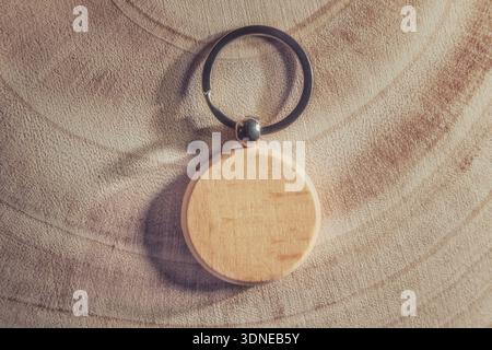 Blank round wooden keychain on wood background Stock Photo