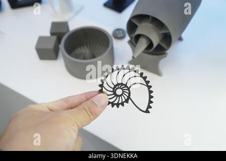 hand with metal shell object printed on 3d printer close-up Stock Photo