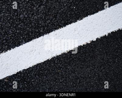 a white line on a tarmac road Stock Photo