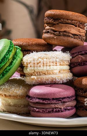 Assorted macarons stacked on decorative plate Stock Photo