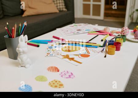 Easter Egg Drawings and Paints Arranged on Table for Holiday Crafting Stock Photo
