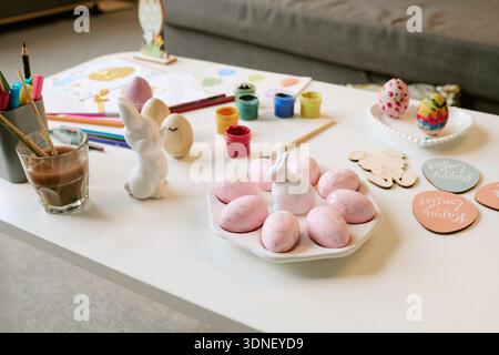 Easter Eggs and Art Supplies Arranged on Table for Holiday Crafting Stock Photo