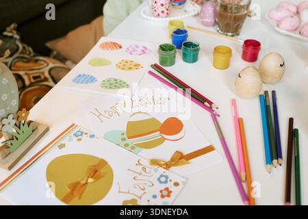 Easter Greeting Cards and Painted Eggs Being Created with Colored Pencils Stock Photo