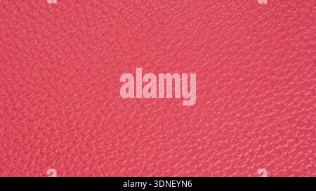 Vibrant pink leather texture enveloped in light, showcasing intricate patterns and richness of craftsmanship Stock Photo