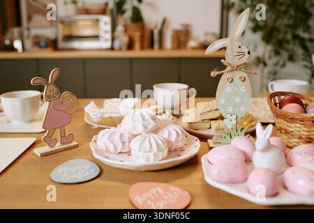 Easter Table Setting Featuring Decorative Bunnies and Festive Sweets Stock Photo