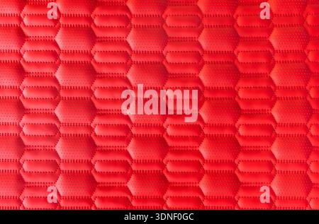 red leather background and texture as a pattern for the interior car or a sofa or wall covering Stock Photo