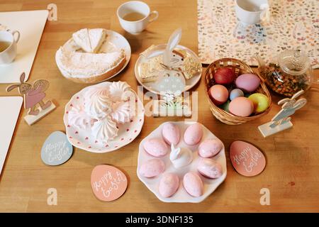 Easter Table Setting Featuring Painted Eggs and Festive Holiday Desserts Stock Photo