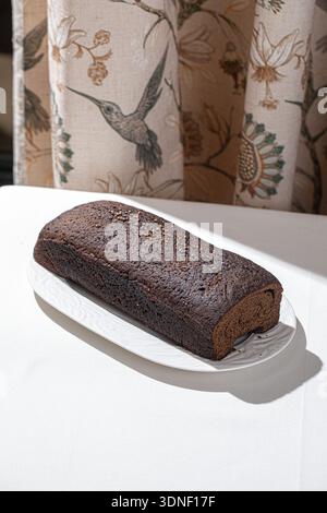 Fresh rye bread loaf on white plate Stock Photo