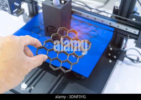 hand with Object printed on 3d printer close-up. Stock Photo