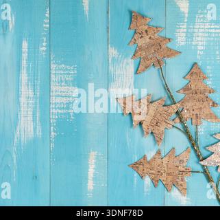 christmas decorated little fir tree shaped branch on blue wooden background Stock Photo