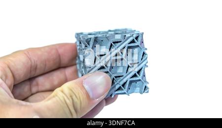 hand with metal object printed on 3d printer close-up Stock Photo