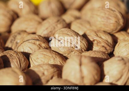 Walnuts collected in a basket at a market during autumn Stock Photo