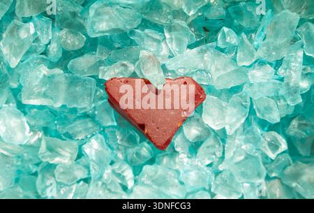 Glass pieces close up found in the sea with shape of red heart glass Stock Photo