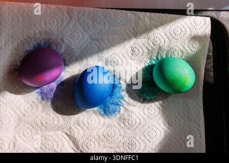 Colored easter eggs drying on paper towel in sunlight. Close up Stock Photo