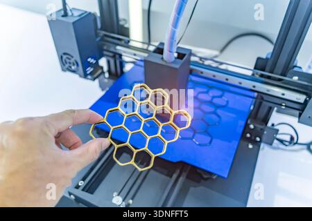 hand with Object printed on 3d printer close-up. Stock Photo
