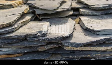 Stack flat slate stones cladding of wall used for flooring, walkways or wall decoration.Background texture Stock Photo