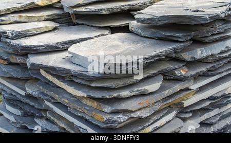Stack flat slate stones cladding of wall used for flooring, walkways or wall decoration.Background texture Stock Photo