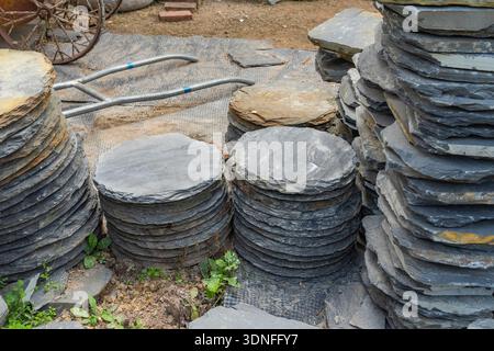 Stack flat slate stones cladding of wall used for flooring, walkways or wall decoration.Background texture Stock Photo