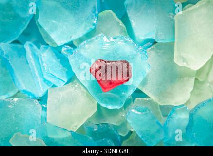 Glass pieces close up found in the sea with shape of red heart glass Stock Photo