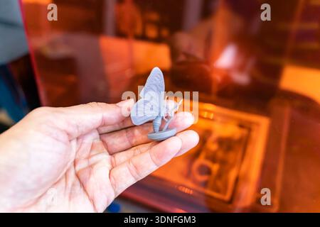 hand with object in shape of butterfly toy printed on 3d printer Stock Photo