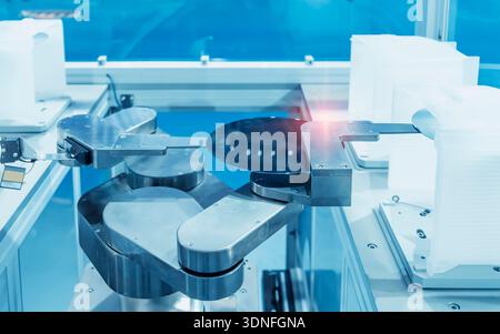 automate robot arm with silicon wafers and microcircuits and Automation system control application in smart factory Stock Photo