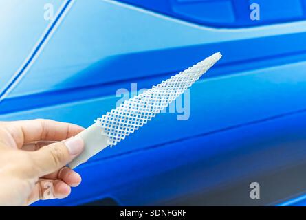 hand with flexible object printed on 3d printer close-up Stock Photo