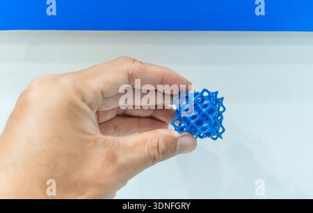 hand with flexible object printed on 3d printer close-up Stock Photo