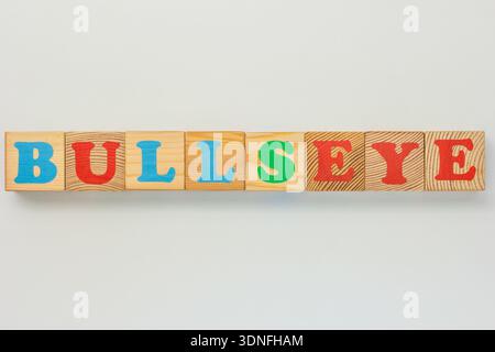 Brightly colored wooden letter blocks forming the phrase Bullseye Stock Photo