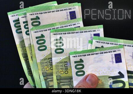 Pensioner counting euro banknotes with the text "Pension" Stock Photo