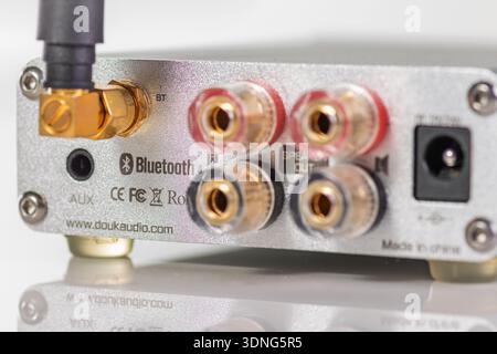 VINKOVCI, CROATIA, 01.16.2021:A close-up of the rear panel on a compact audio interface showing Bluetooth, RCA, and speaker outputs, plus power input. Stock Photo
