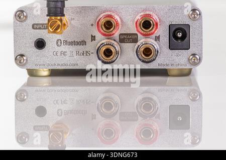 VINKOVCI, CROATIA, 01.16.2021:A close-up of the rear panel on a compact audio interface showing Bluetooth, RCA, and speaker outputs, plus power input. Stock Photo