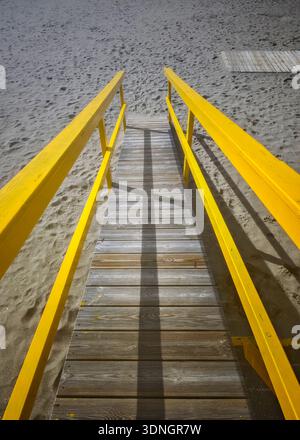Yellow wooden ramp on the beach Stock Photo