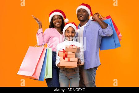 Group of Friends Celebrating With Gifts and Shopping Bags During the Holiday Season Stock Photo