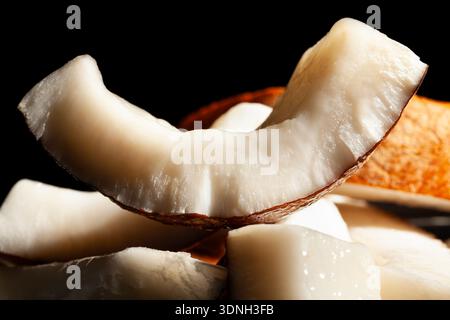 sliced coconut on black background Stock Photo