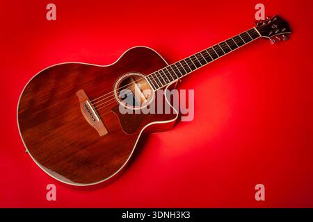 acoustic guitar on red background Stock Photo