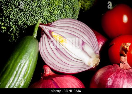 sliced red onion vegetable mix on black background Stock Photo