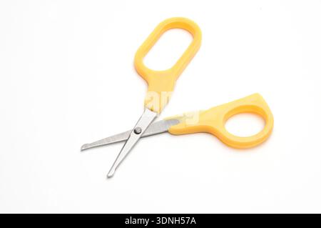 Yellow baby scissors on an isolated white background/Blue baby scissors on an isolated white background Stock Photo
