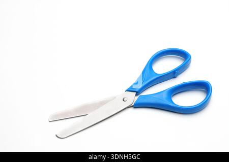 Blue baby scissors on an isolated white background/Blue baby scissors on an isolated white background Stock Photo