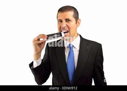 Portrait of a frustrated young businessman bitting the cell phone and breaking the screen isolated on white background Stock Photo