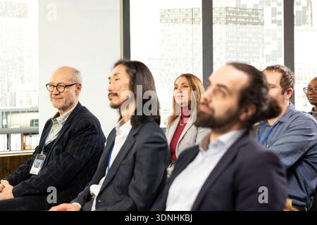 Diverse people in audience listening to guest speaker during business forum with panel discussion, international conference event. Professionals and listeners attend leadership convention. Stock Photo