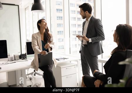 Diverse team members engaged in group meeting in coworking office Stock Photo