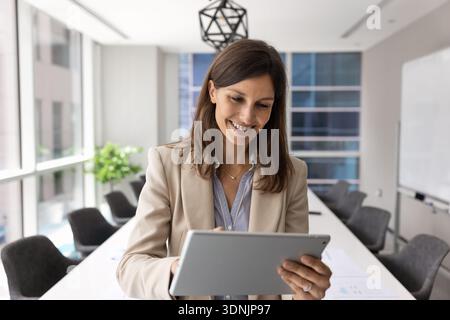 Businesslady, business analyst or corporate trainer working on tablet Stock Photo