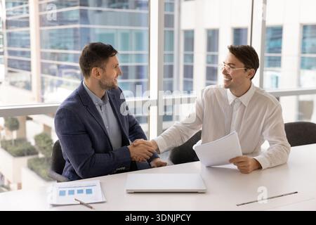 Two businessmen shaking hands in gesture of agreement Stock Photo